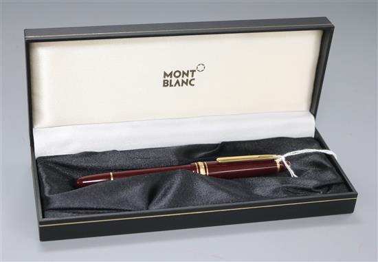 A Montblanc Meisterstuck burgundy and gold-coloured fountain pen, boxed